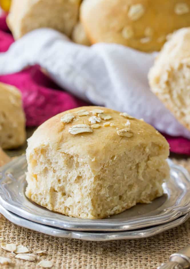 Soft and fluffy honey wheat rolls brushed with honey and topped with oats
